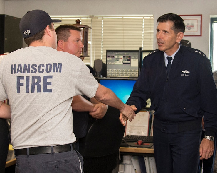 HANSCOM AIR FORCE BASE, Mass. – Lt. Gen. C.D. Moore II, Air Force Life Cycle Management Center commander, thanks Jeffrey Forcier, Jason Pelletier and other Hanscom firefighters for their quick response to an aircraft crash, July 8. Firefighters assigned to Hanscom's Fire Emergency Services responded May 31 to Hanscom Field after a private Gulfstream IV aircraft departing the field crashed at the end of the runway. (U.S. Air Force photo by Walter Santos)