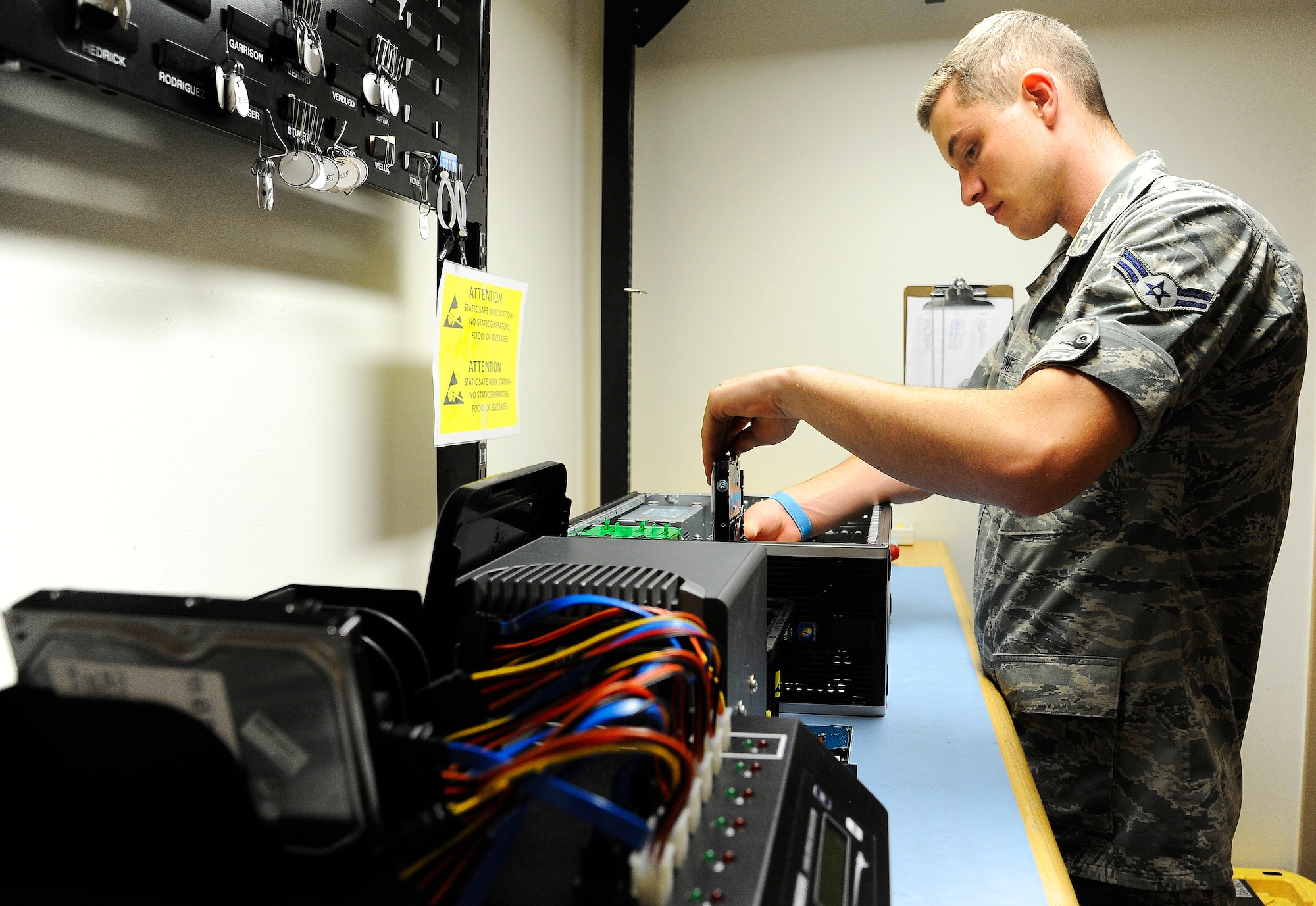 Airman 1st Class Daniel Rome, 341st Communications Squadron client support technician, installs a hard drive into a Hewlett Packard 6005 computer during a refurbishment project July 10. Client support technicians are trained in a variety of specialties to include the full repair and installation of computers, printers and integrated electronic systems. (U.S. Air Force photo/Airman 1st Class Collin Schmidt) 