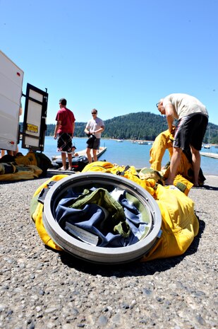 Survival, Evasion, Resistance, and Escape specialists distribute U-2 flight suits for water survival training July 3, 2014, at a lake in Nevada City, Calif. Water survival training for U-2 and MC-12 aircrew members is part of mandatory training to learn how to properly use survival equipment. (U.S. Air Force photo by Airman 1st Class Ramon A. Adelan/ Released) 
