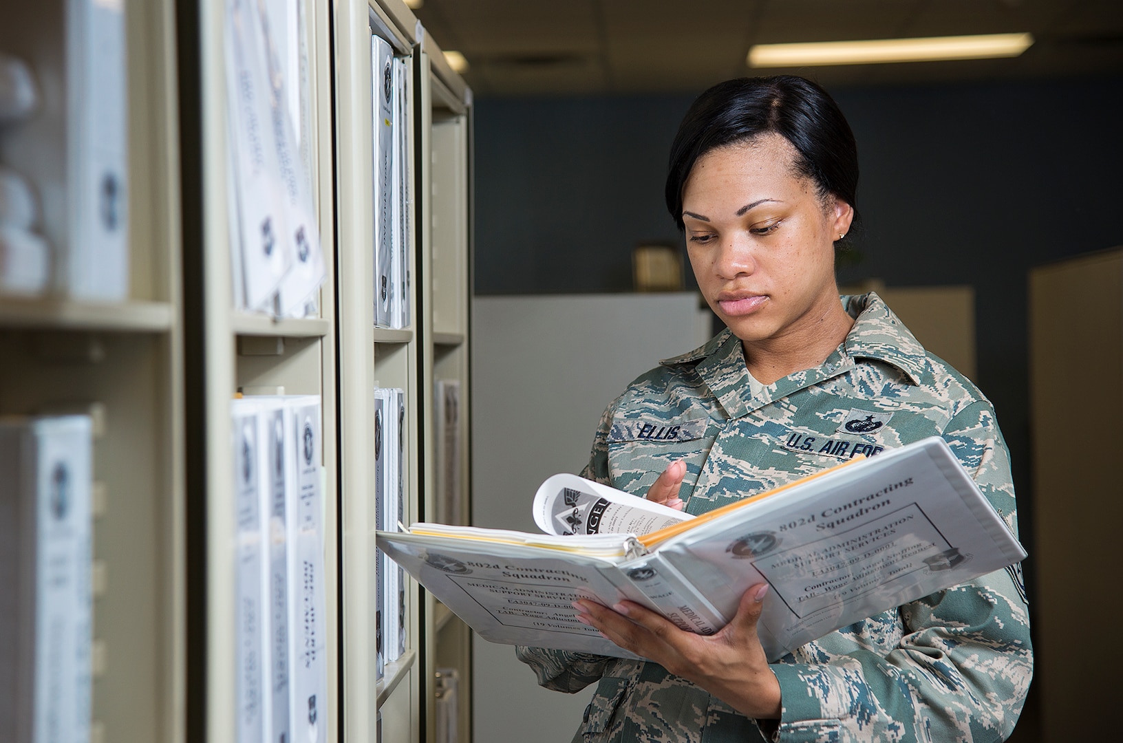 Tech. Sgt. Latoria Ellis, 502nd Contracting Squadron contracting officer reviews the contracting policy and procedures June 26, at Joint Base San Antonio-Lackland. Tech. Sgt. Ellis was awarded the 12th Outstanding Airman of the Year award for 2014.  (U.S. Air Force photo by Benjamin Faske) (released)