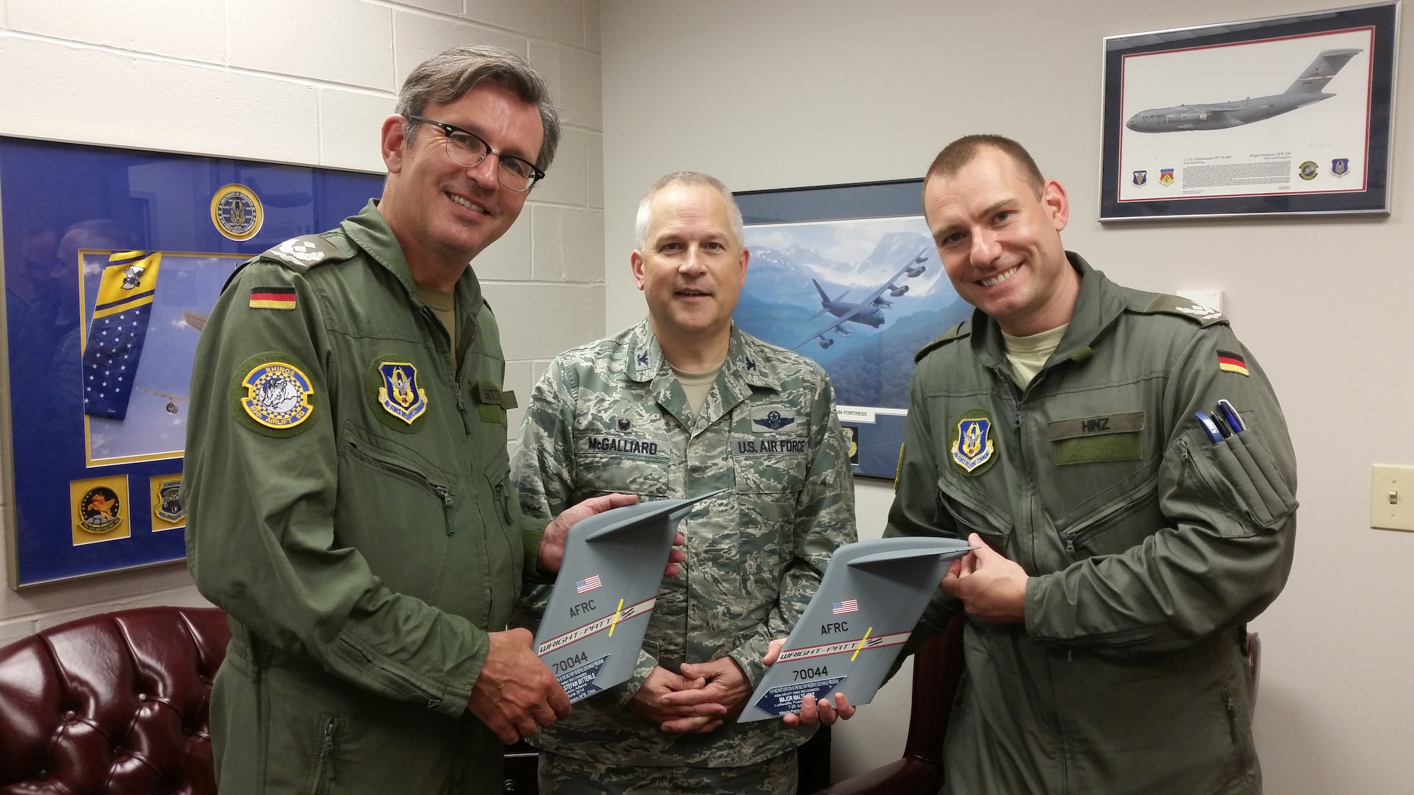 WRIGHT-PATTERSON AIR FORCE BASE – Ohio 
Col. Jeffrey McGalliard, 445th Airlift Wing commander presents C-17 tail flashes to Lt. Col. Stefan Bitterle, Luftwaffe public affairs officer and Maj. Malte Hinz, Luftwaffe internal security officer during their visit to the 445th Airlift Wing June 20, 2014. The 445th Airlift Wing hosted two German officers as part of the Reserve Foreign Officer Exchange Program. (Courtesy Photo)