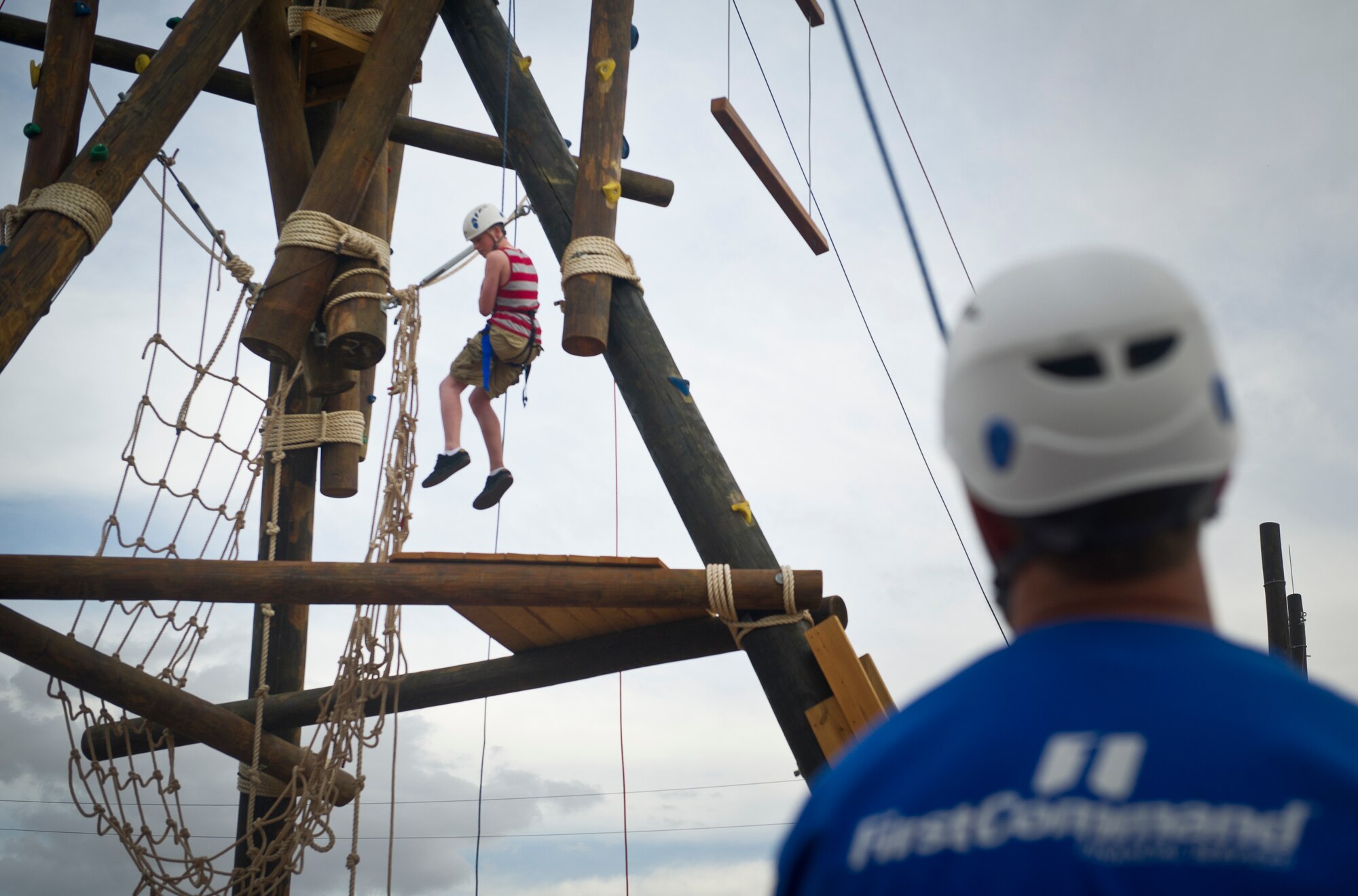 An Airmen hangs from the ropes course during the Freedom Fest Independence Day celebration at Holloman Air Force Base, N.M., July 3. Freedom Fest took place in the Domenici Fitness and Sports Center parking lot and included carnival games, rides, and live music for Airmen and their families. (U.S. Air Force photo by Airman 1st Class Aaron Montoya/Released)