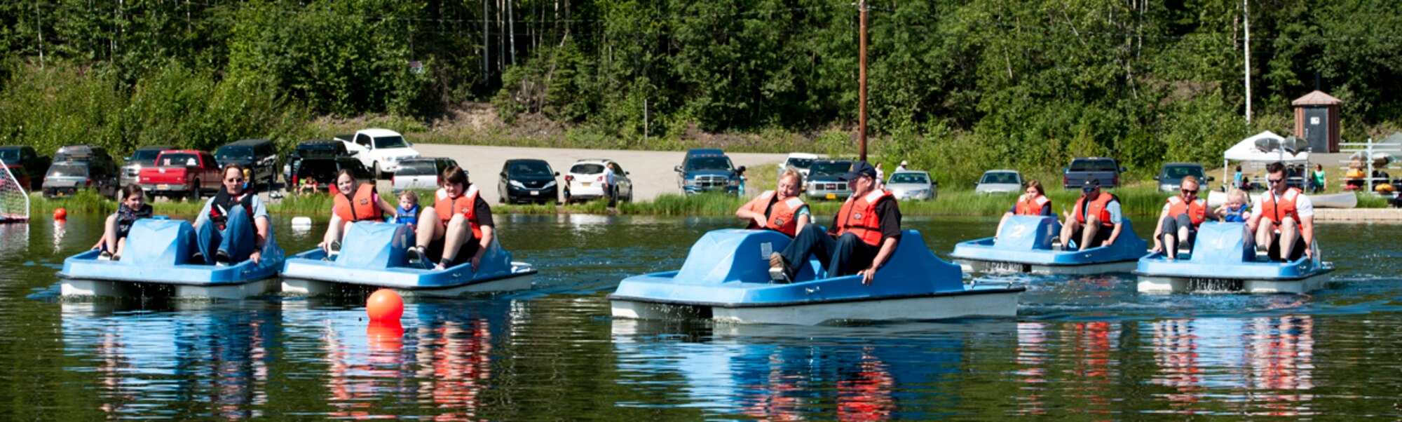 Military members and their families begin the paddle boat race during the second annual Otter Fest on Joint Base Elmendorf-Richardson, Alaska, July 5, 2014. Paddle boat, stand-up paddle boat, and kayak races were a few of the many events held during the fest. (U.S. Air Force photo/Airman 1st Class Tammie Ramsouer)