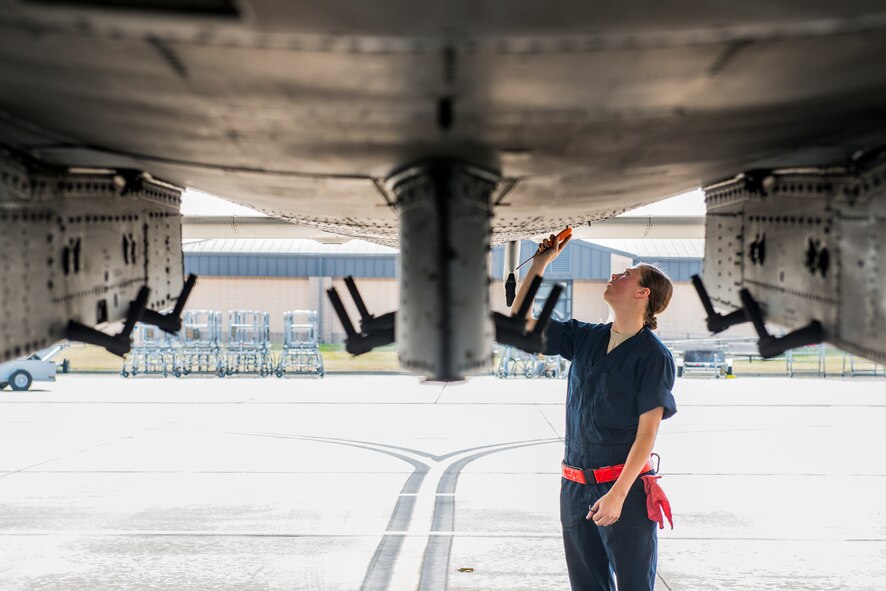 U.S. Air Force Airman 1st Class Robin Burke, 23d Aircraft Maintenance Squadron dedicated crew chief, performs a post-flight inspection on an A-10C Thunderbolt II at Moody Air Force Base, Ga., July 9, 2014. Burke scanned for bolts that may have loosened during flight. (U.S. Air Force photo by Airman 1st Class Ryan Callaghan/Released)