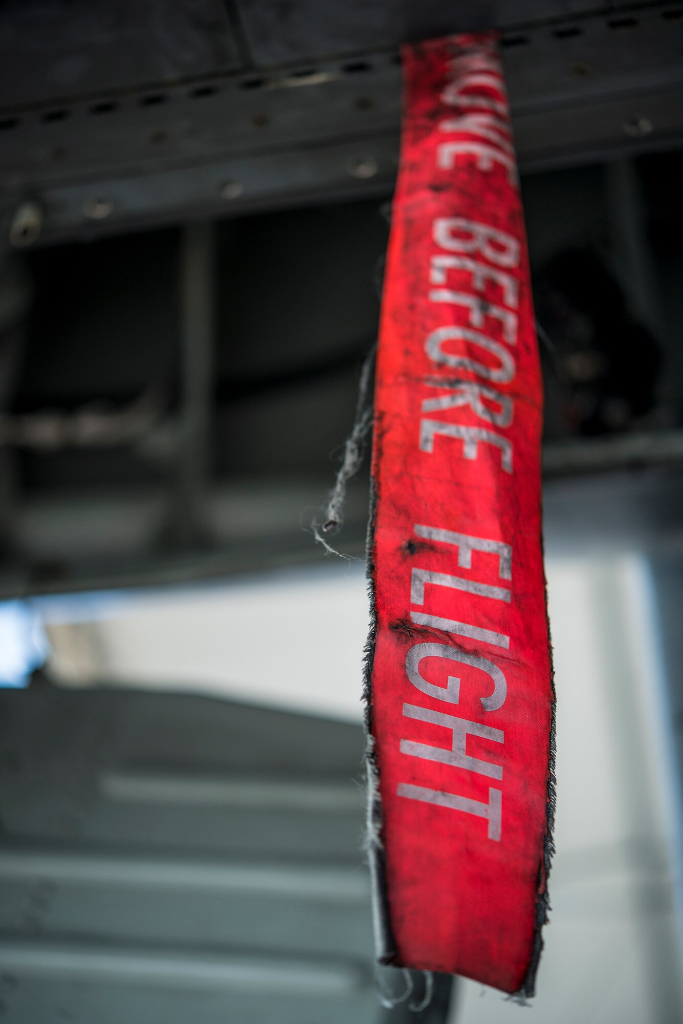 A streamer hangs from the underside of an A-10C Thunderbolt II at Moody Air Force Base, Ga., July 10, 2014. Streamers are attached to all of the aircraft’s safety pins and covers, and act as a vibrant, visual indication that these pieces are still in place. (U.S. Air Force photo by Airman 1st Class Ryan Callaghan/Released)