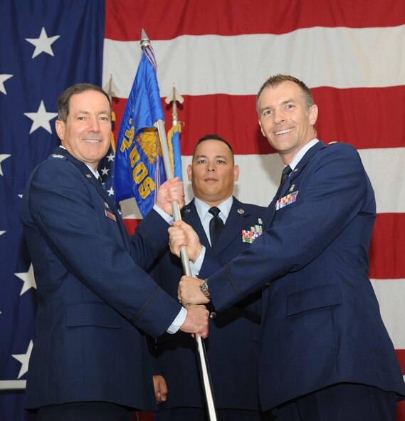 Lt. Col. Daniel Loveless, the 71st Medical Operations Squadron commander, accepts the 71st MDOS guidon from Col. David Chiesa, the 71st Medical Group commander, during a change-of-command ceremony June 30 at the Armed Forces Reserve Center. (U.S. Air Force photo/Staff Sgt. Nancy Falcon)
