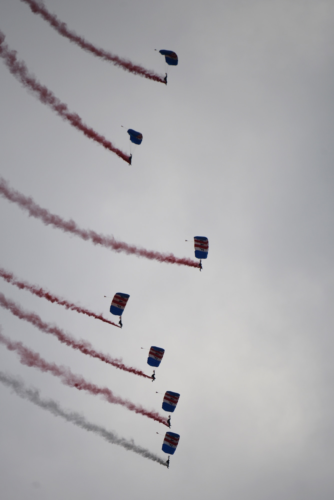 Members of the RAF Falcons, the United Kingdom’s premier military parachute display team, descend upon RAF Croughton, U.K., during the on-base Fourth of July festival, July 3, 2014. The RAF Falcons display format adjusts for varying shows for different weather conditions. (U.S. Air Force photo by Tech. Sgt. Chrissy Best/Released)