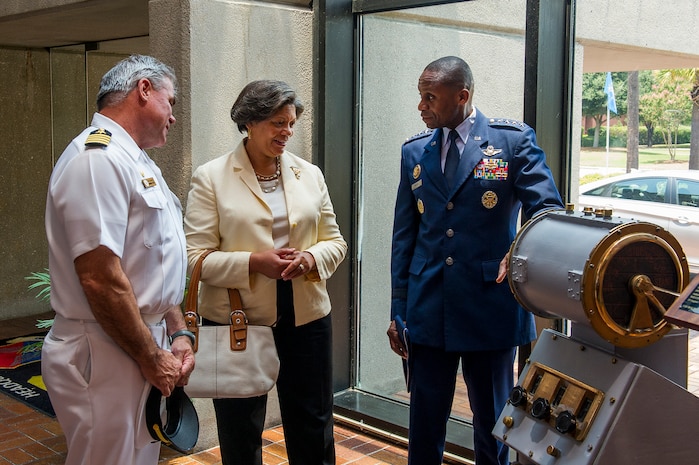 Navy Capt. Timothy Sparks, Joint Base Charleston deputy commander, talks to Gen. Darren McDew, Air Mobility Command, and his wife Evelyn, July 9, 2014, at JB Charleston, S.C. McDew visited JB Charleston to get a firsthand look at how joint basing builds closer relationships and forges stronger ties between our sister services. (U.S. Air Force photo/Senior Airman George Goslin)