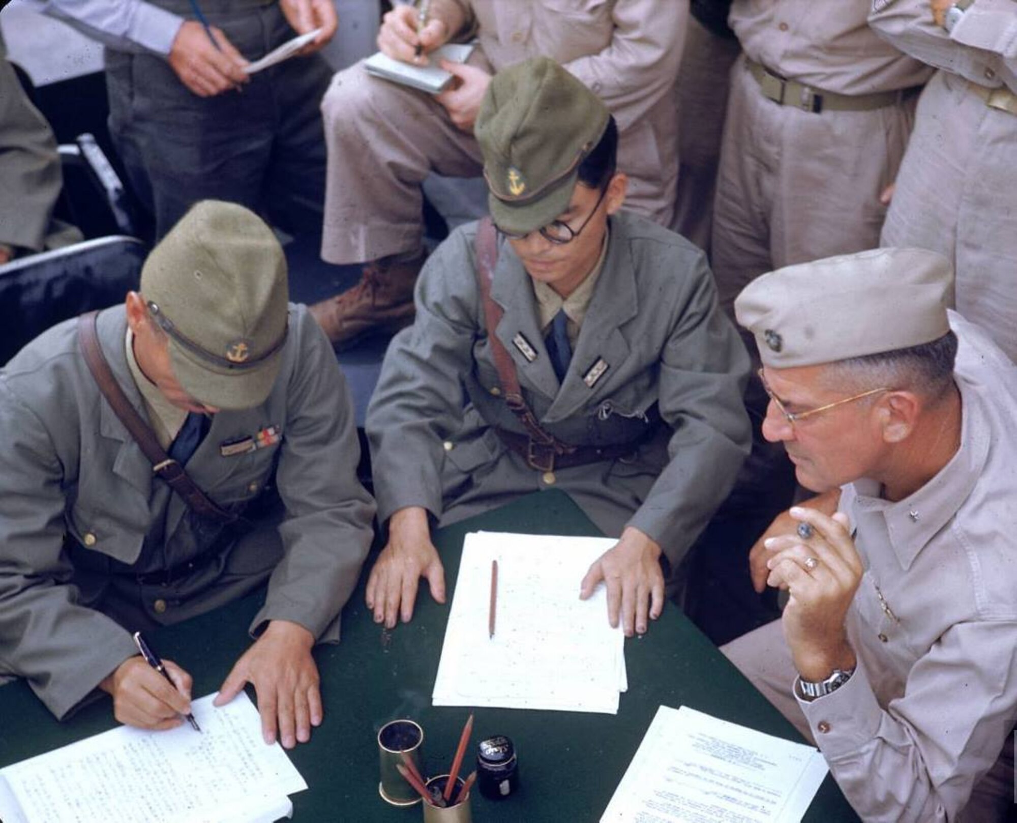 Aboard the USS Levy (DE-162), Japanese Rear Admiral Shigematsu Sakaibar (left) signs a document surrendering control of Wake Island to Marine Brig. General Lawson H. M. Sanderson (right) and U.S. forces, September 4, 1945. Sanderson, who is called the “father of dive-bombing” by the Marines, once crashed an experimental aircraft into Lake St. Clair during a 1922 flight from Selfridge Field. Sanderson was buried in mud in the lake bottom after the crash, but managed to dig himself out to emerge unharmed. (U.S. Navy photo)