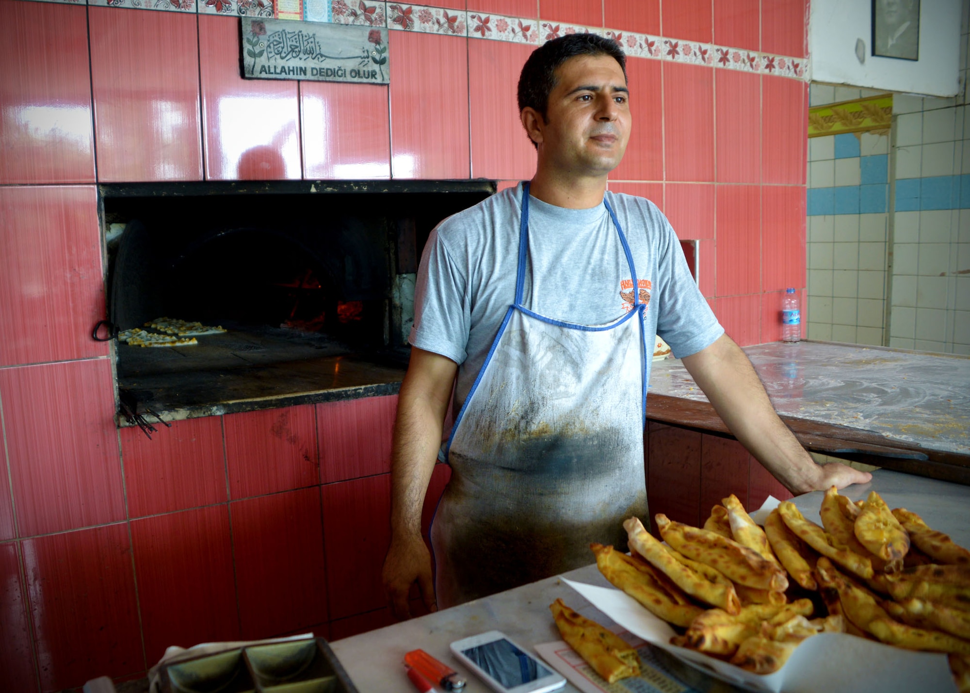 A man waits for bread to bake at a local bakery July 9, 2014, near Incirlik Air Base, Turkey. This month marks the holy month of Ramazan for Muslims. During the month, most Muslims participate in fasting during daylight hours, which they abstain from food and drink. Bakeries offer specialty breads during this time for their evening meal. (U.S. Air Force photo by Staff Sgt. Veronica Pierce/Released)