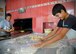 At a local bakery in a village near Incirlik Air Base, Turkey, a boy helps prepare bread for the breaking of fast during Ramazan July 9, 2014. During this month, Muslims around world fast. At night families and friends gather for dinner to break the fast.  Many locals go to bakeries to buy a specialty breads baked during Ramazan. (U.S. Air Force photo by Staff Sgt. Veronica Pierce/Released) 