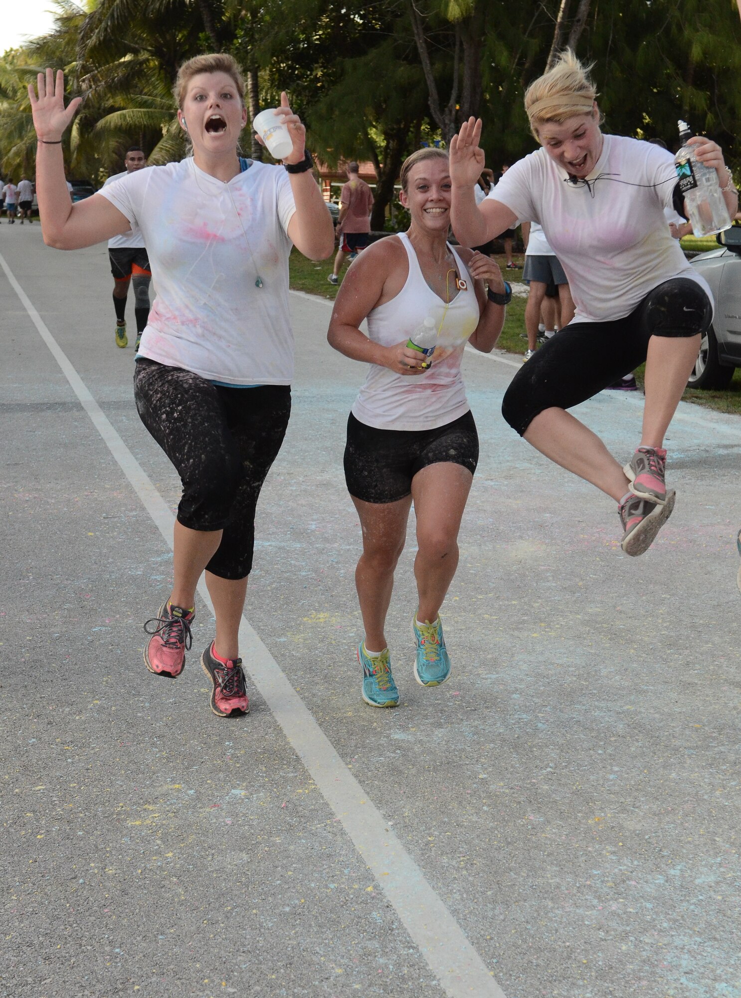 Participants of the Freedom Blast 5K Color Run celebrate near the finish line July 3, 2014, on Andersen Air Force Base, Guam. Nearly 300 people participated in the 5K which kicked off the Independence Day weekend. (U.S. Air Force photo by Airman 1st Class Emily A. Bradley/Released)