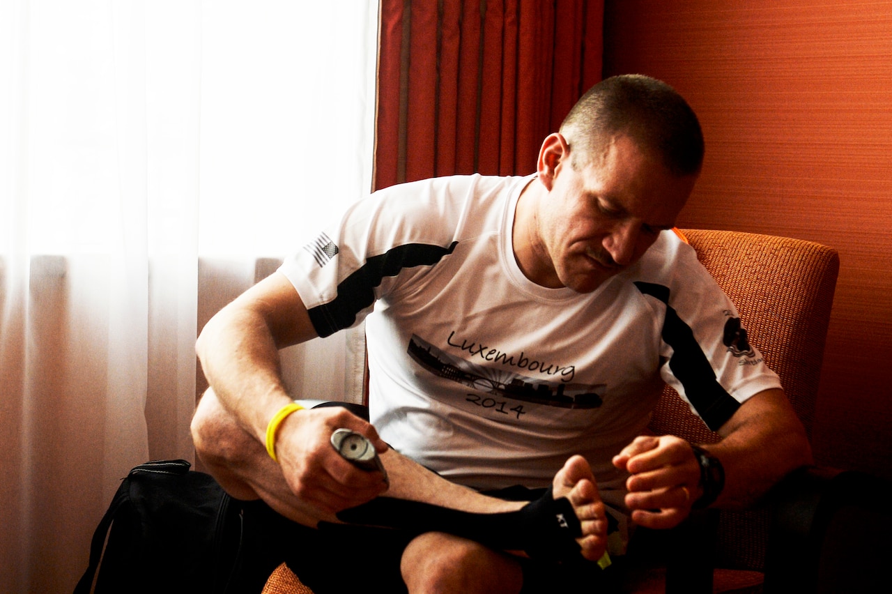 Air Force Master Sgt. Donald Stichter prepares his feet prior to the start of the ING Luxembourg Night Marathon, May 31, 2014. Stichter trained for more than five months to get ready for the race. U.S. Air Force photo by Senior Airman Rusty Frank