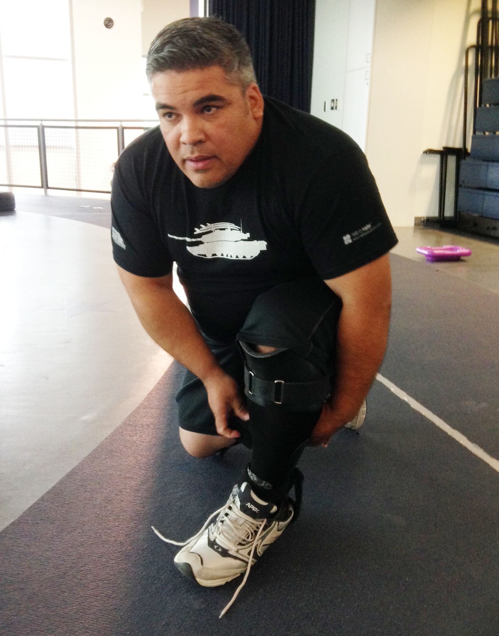 Retired Army Sgt. 1st Class Frank Larraza straps on an Intrepid Dynamic Exoskeletal Orthosis, or IDEO, in preparation for a run at the Center for the Intrepid, Brooke Army Medical Center’s outpatient rehabilitation facility on Joint Base San Antonio-Fort Sam Houston, Texas. U.S. Army photo by Elaine Sanchez