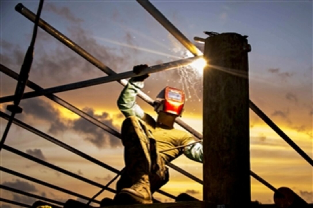 U.S. Marine Corps Cpl. David Merrifield completes an obstacle course the U.S. Marines built at Price Barracks in Ladyville, Belize, June 30, 2014. The Marines are in Belize as part of Southern Partnership Station 2014, a U.S. Navy and Marine Corps deployment focused on subject matter expert exchanges with partner nation militaries and security forces in Central and South America and the Caribbean.