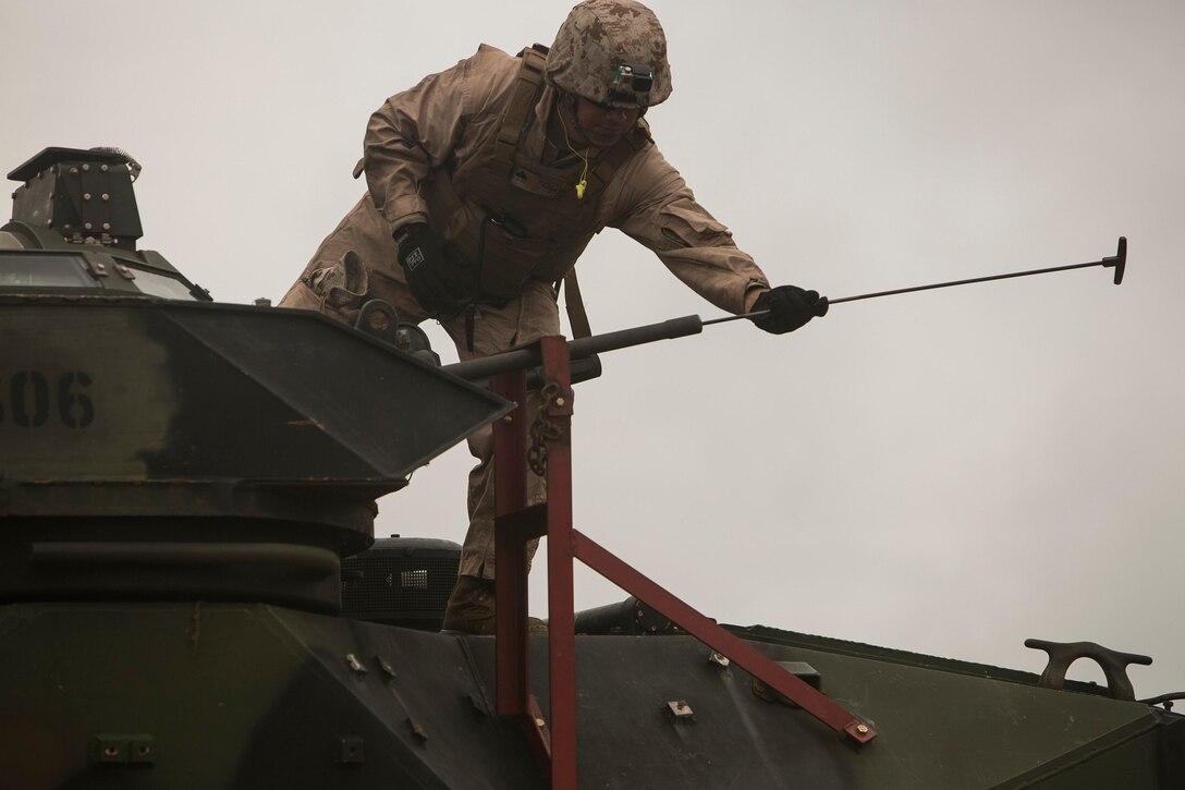 Staff Sgt. Eric Boyd, a Pinetop, Arizona, native, clears the barrel of an M240B machine gun after it finished firing June 25 at Camp Schwab. Marines fired various weapons mounted on assault amphibious vehicles to prepare for a live-fire maneuver in July as part of the Korean Marine Exchange Program. Williams is an AAV crewman with 3rd Assault Amphibian Battalion, currently assigned to Combat Assault Battalion, 3rd Marine Division, III Marine Expeditionary Force, under the unit deployment program.