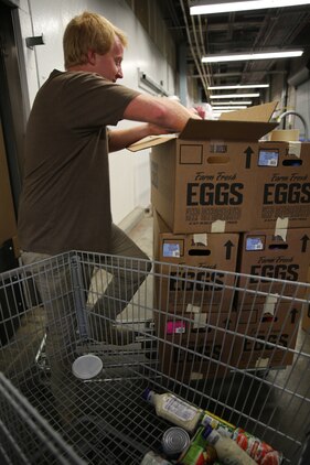 Steven Doyle fills boxes with unsellable food to donate to the Food Bank of Central and Eastern North Carolina at the Cherry Point Commissary, July 2, 2014. The commissary established a partnership with the food bank early this year and has since donated more than 30,000 pounds of food to local charities. Doyle is a 6-year commissary employee who has help package items for the food back since the partnership began.


