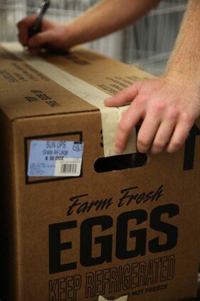 Steven Doyle marks a box of donations for delivery to the Food Bank of Central and Eastern North Carolina at the Cherry Point Commissary July 2, 2014. Doyle has been a commissary store employee for six years and is the stores main employee in charge of packing food for weekly donations.


