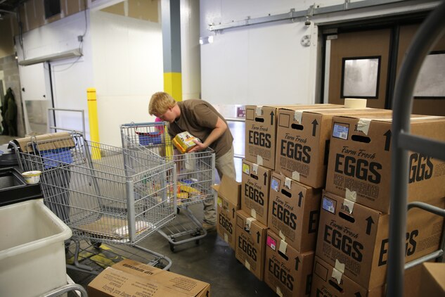 Steven sorts a cart of unsellable items at the Cherry Point Commissary for donation to the Food Bank of Central and Eastern North Carolina July 2, 2014. Doyle is a commissary worker who sorts and packs unsellable food for donations to local food banks.


