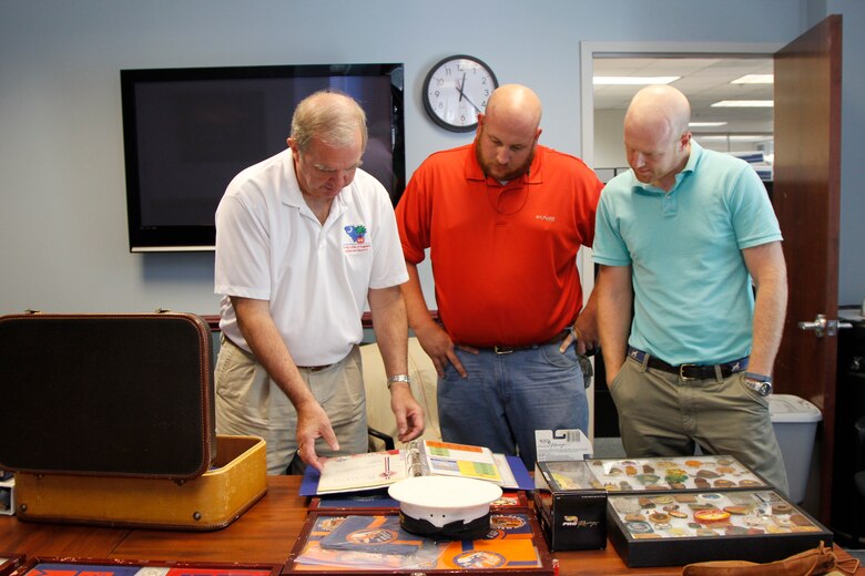 The Charleston District has nine Eagle Scouts in our approximately 250 employees. Each of these Eagle Scouts has a different story about their experience. Here, Joe Moran, Caleb Brewer and Sean McBride look at Moran's collection of Boy Scouts memorabilia.