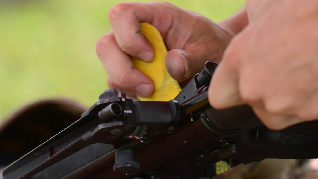 Marine Sgt. Nathaniel Jagger examines an M-16 competition rifle at the 53rd Annual Interservice Rifle Championship aboard Marine Corps Base Quantico, Virginia, July 7, 2014. The competitor’s rifles are weighted to fit their individual needs, allowing them to keep steady aim and reduce the recoil from heavy bullets. Jagger is a precision weapons specialist with Weapons Training Battalion, Marine Corps Base Quantico.