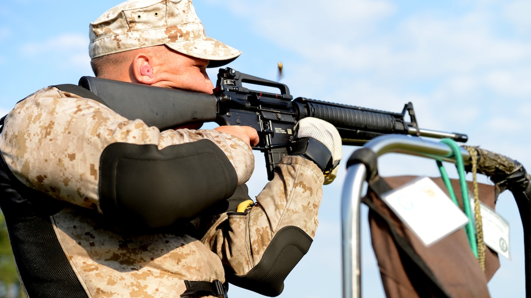 Cpl. Antonio Diconza fires a weighted M-16 rifle at the 53rd Annual Interservice Rifle Championship aboard Marine Corps Base Quantico, Virginia, July 7, 2014. The competitors’ rifles are weighted to fit their individual needs, allowing them to keep steady aim and reduce the recoil from heavy bullets. Diconza is an infantry mortarman and competitive shooter with the Marine Corps Rifle Team.