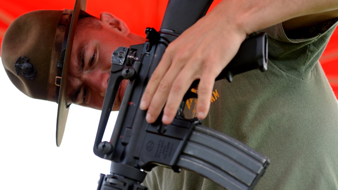 Marine Sgt. Nathaniel Jagger examines an M-16 competition rifle at the 53rd Annual Interservice Rifle Championship aboard Marine Corps Base Quantico, Virginia, July 7, 2014. The competitors’ rifles are weighted to fit their individual needs, allowing them to keep steady aim and reduce the recoil from heavy bullets. Jagger is a precision weapons specialist with Weapons Training Battalion, Marine Corps Base Quantico.