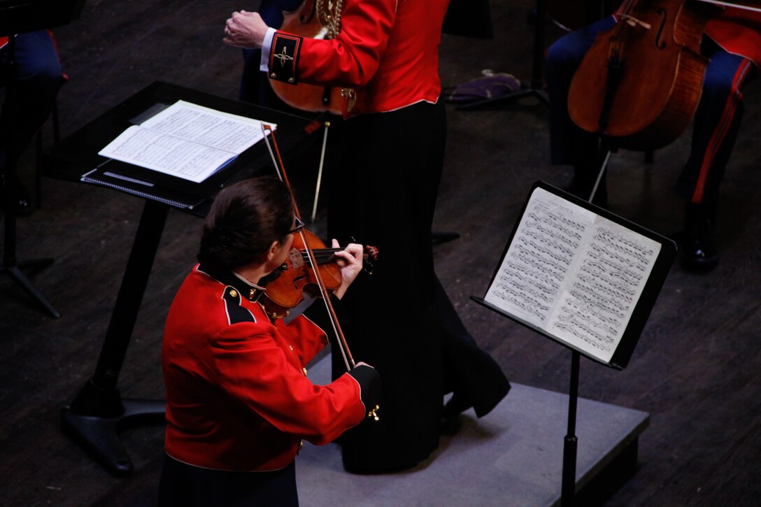 On June 7, 2014, Capt. Michelle A. Rakers conducted the Marine Chamber Orchestra and soloist concertmaster Master Gunnery Sgt. Claudia Chudacoff in concert at the Rachel M. Schlesinger Concert Hall and Arts Center in Alexandria, Va. (U.S. Marine Corps photo released/Staff Sgt. Rachel Ghadiali)