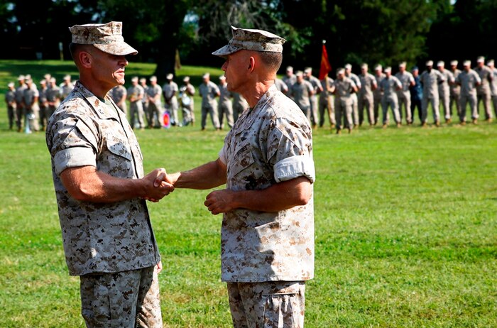 Col. Joseph Shrader (left) and Brig. Gen. Frank Kelley shake hands following the passing of the organizational colors during the Marine Corps Systems Command change of command ceremony July 11 on Hospital Point aboard Marine Corps Base Quantico, Virginia. Kelley, who served as commander since July 2010, relinquished command to Shrader. 