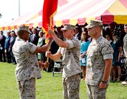 Sgt. Maj. Fletcher Pearson (left), Marine Corps Systems Command sergeant major, passes the MCSC organizational flag to Brig. Gen. Frank Kelley during the Marine Corps Systems Command change of command ceremony July 11 on Hospital Point aboard Marine Corps Base Quantico, Virginia. Kelley, who served as commander since July 2010, relinquished command to Shrader (right).