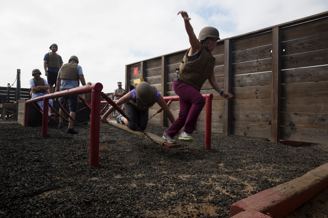 CAMP PENDELTON, Calif. - Tracey Tran, a teacher with C.K. McClatchy High School, Recruiting Station Sacramento, leaps to finish an obstacle in the Leadership Reaction Course as part of an Educators’ Workshop here, July 10, 2014. The educators and community leaders are given the chance to learn about the transition from civilian to Marine and what is expected of a Marine on a day-to-day basis to better understand what the Marine Corps can offer for a transitioning young man or woman. (Official U.S. Marine Corps Photo by Sgt. Rebecca Eller)