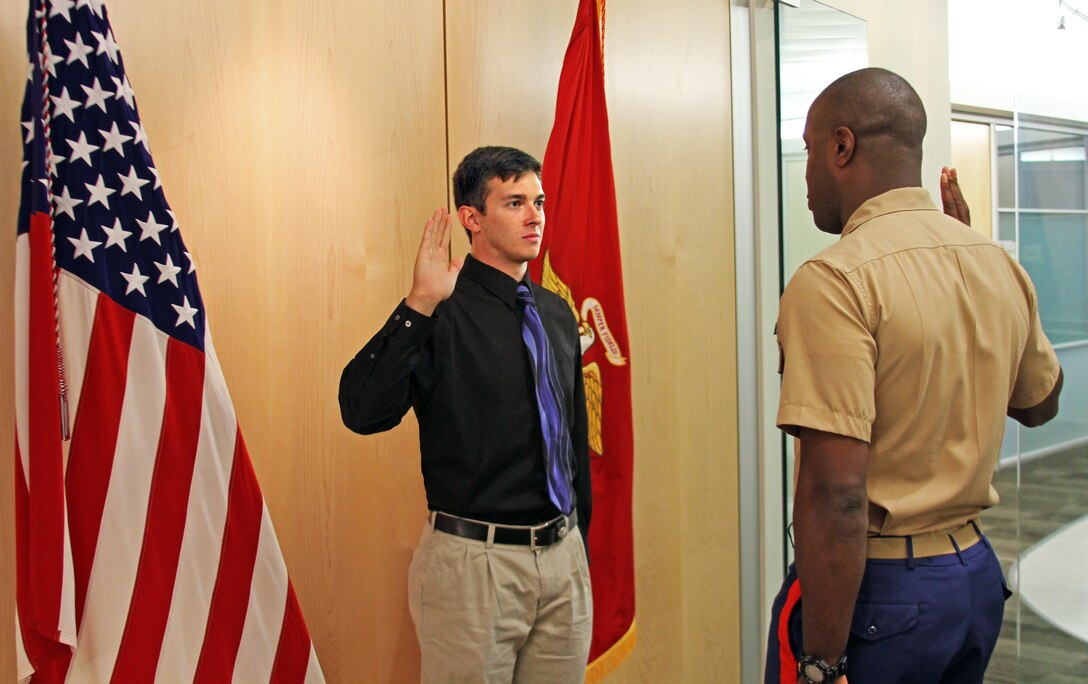 U.S. Marine Corps officer candidate Jamie Gastrich, a native of Richmond, Va., recites the oath of office as administered by U.S. Marine Corps Capt. Devin Claridy, an officer selection officer for Officer Selection Station Norfolk in Norfolk, Va., July 7, 2014. Gastrich, a junior at Old Dominion University, became the first candidate to contract from Recruiting Station Richmond’s newest officer selection station. (U.S. Marine Corps photo by Cpl. Aaron Diamant/Released)