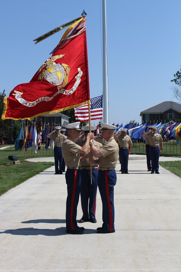 U.S. Marine Corps Col. Terence D. Trenchard, (right), passes the flag to U.S. Marine Corps Col. John A. Bolt, (left), signifying the changing of command during a change of command ceremony for the 4th Marine Corps District at the Defense Distribution Center Susquehanna in New Cumberland, Pa., July 10, 2014. Trenchard, a Hartford, Conn. native, relinquished command of the district to Bolt, a Mount Dora, Fla. native, following three successful years as the district’s commanding officer. Bolt was most recently the J3 Air Fires Officer, Naval Striking and Support Forces, NATO. Trenchard will assume the post of operations officer for Marine Corps Recruiting Command. (U.S. Marine Corps photo by Cpl. Nicholas S. Ranum/Released)  