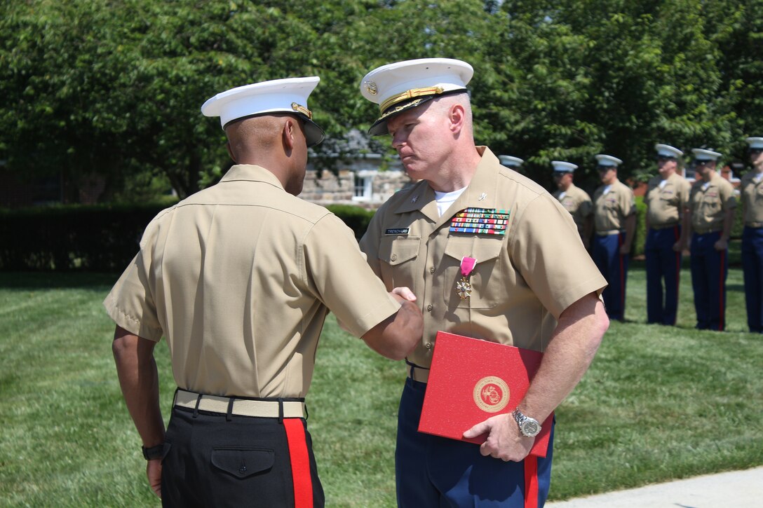 U.S. Marine Corps Col. Terence D. Trenchard is awarded the Legion of Merit by Brig. Gen. Terry Williams, the commanding general of Eastern Recruiting Region and Marine Corps Recruit Depot Parris Island, S.C., at the Defense Distribution Center Susquehanna in New Cumberland, Pa., July 10, 2014. Trenchard, a Hartford, Conn. native, was awarded the Legion of Merit after his successful completion of his time at 4th Marine Corps District. Trenchard will assume the post of operations officer for Marine Corps Recruiting Command after relinquishing the command of the district to Col. John A. Bolt, a Mount Dora, Fla. native. (U.S. Marine Corps photo by Cpl. Nicholas S. Ranum/Released)  