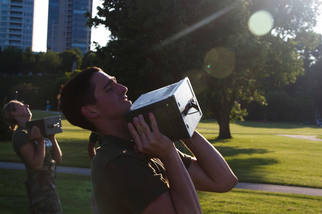 Applicant Jacob Pipping ammo can lifts during the Combat Fitness Test at Veterans Park in Milwaukee, Wis., July 10, 2014.  Officer Selection Station Milwaukee conducted a Combat Fitness Test to help prepare their officer candidates and applicants for Officer Candidates School.