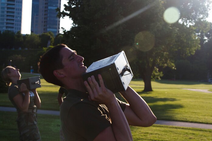 Applicant Jacob Pipping ammo can lifts during the Combat Fitness Test at Veterans Park in Milwaukee, Wis., July 10, 2014.  Officer Selection Station Milwaukee conducted a Combat Fitness Test to help prepare their officer candidates and applicants for Officer Candidates School.