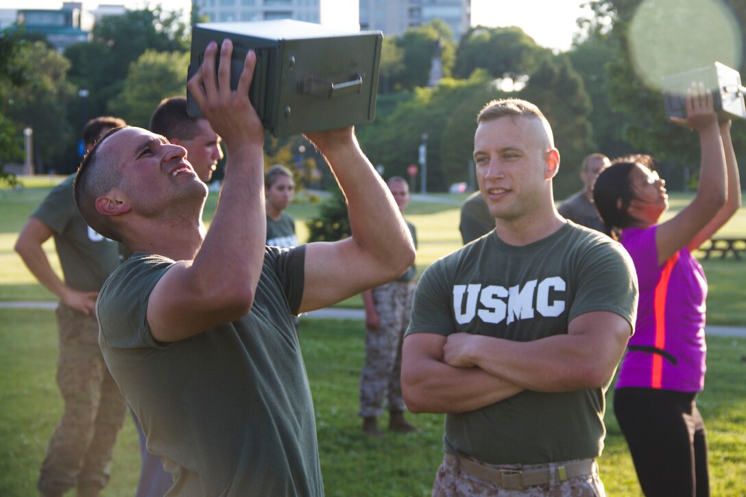 Candidate Alexander Katerinos performs ammo can lifts during the Combat Fitness Test at Veterans Park in Milwaukee, Wis., July 10, 2014.  Officer Selection Station Milwaukee conducted a Combat Fitness Test to help prepare their officer candidates and applicants for Officer Candidates School.