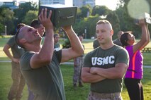 Candidate Alexander Katerinos performs ammo can lifts during the Combat Fitness Test at Veterans Park in Milwaukee, Wis., July 10, 2014.  Officer Selection Station Milwaukee conducted a Combat Fitness Test to help prepare their officer candidates and applicants for Officer Candidates School.