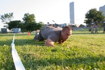 Applicant Nolan McShane executes a high crawl during the maneuver under fire portion of the Combat Fitness Test at Veterans Park in Milwaukee, Wis., July 10, 2014.  Officer Selection Station Milwaukee conducted a Combat Fitness Test to help prepare their officer candidates and applicants for Officer Candidates School.