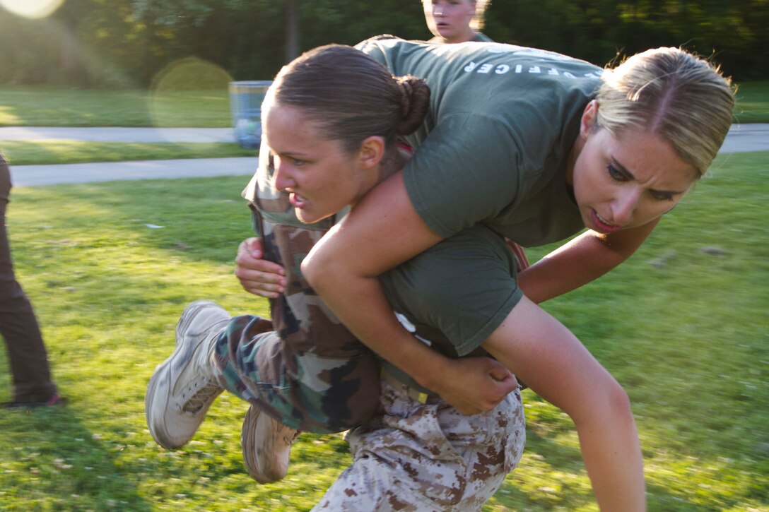 Candidate Lauren Glomski fireman carries simulated casualty, Applicant Brooke Wargolet, during the maneuver under fire portion of the Combat Fitness Test at Veterans Park in Milwaukee, Wis., July 10, 2014.  Officer Selection Station Milwaukee conducted a Combat Fitness Test to help prepare their officer candidates and applicants for Officer Candidates School.