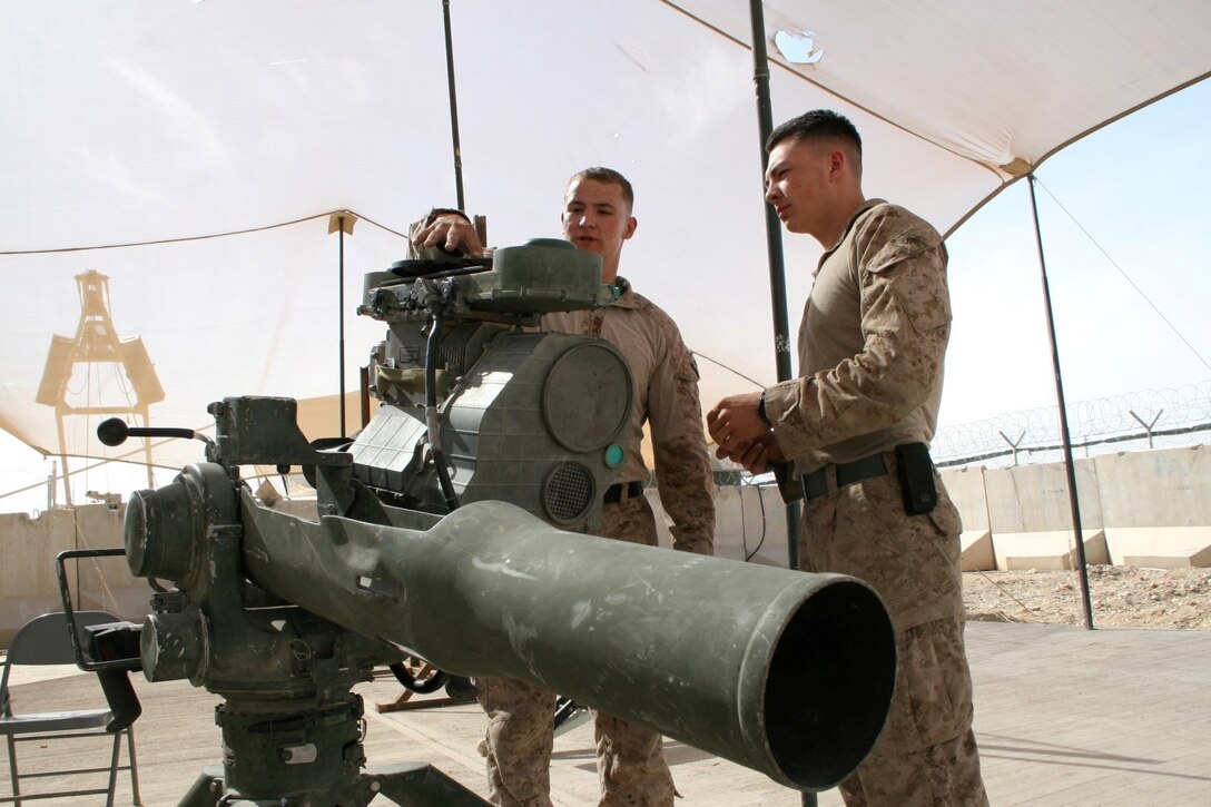 U.S. Marine Sgt. Michael M. Estes, left, 20, a native of Torrance, Calif., and electro-optical ordnance repairer with Combat Logistics Battalion 7, Regional Command (Southwest), performs maintenance on a Tube Launched Optically Tracked, Wire-guided missile system outside of the ordnance maintenance headquarters aboard Camp Leatherneck, Helmand province, Afghanistan, April 9, 2014. Estes deployed to Afghanistan during January 2014, and kept Marine Corps individual and heavy weapons optics in the fight during ongoing security operations and led redeployment and retrograde efforts of Marine Corps equipment from the region.