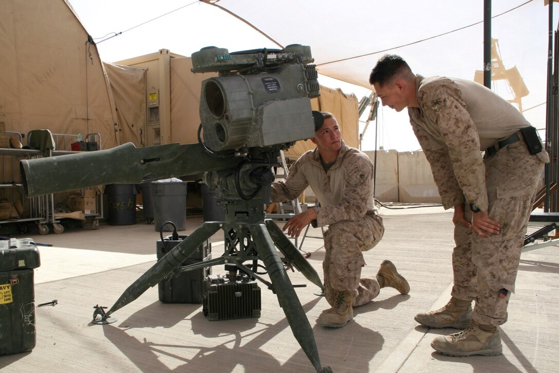 U.S. Marine Sgt. Michael M. Estes, left, 20, a native of Torrance, Calif., and electro-optical ordnance repairer with Combat Logistics Battalion 7, Regional Command (Southwest), performs maintenance on a Tube Launched Optically Tracked, Wire-guided missile system outside of the ordnance maintenance headquarters aboard Camp Leatherneck, Helmand province, Afghanistan, April 9, 2014. Estes deployed to Afghanistan during January 2014, and kept Marine Corps individual and heavy weapons optics in the fight during ongoing security operations and led redeployment and retrograde efforts of Marine Corps equipment from the region.