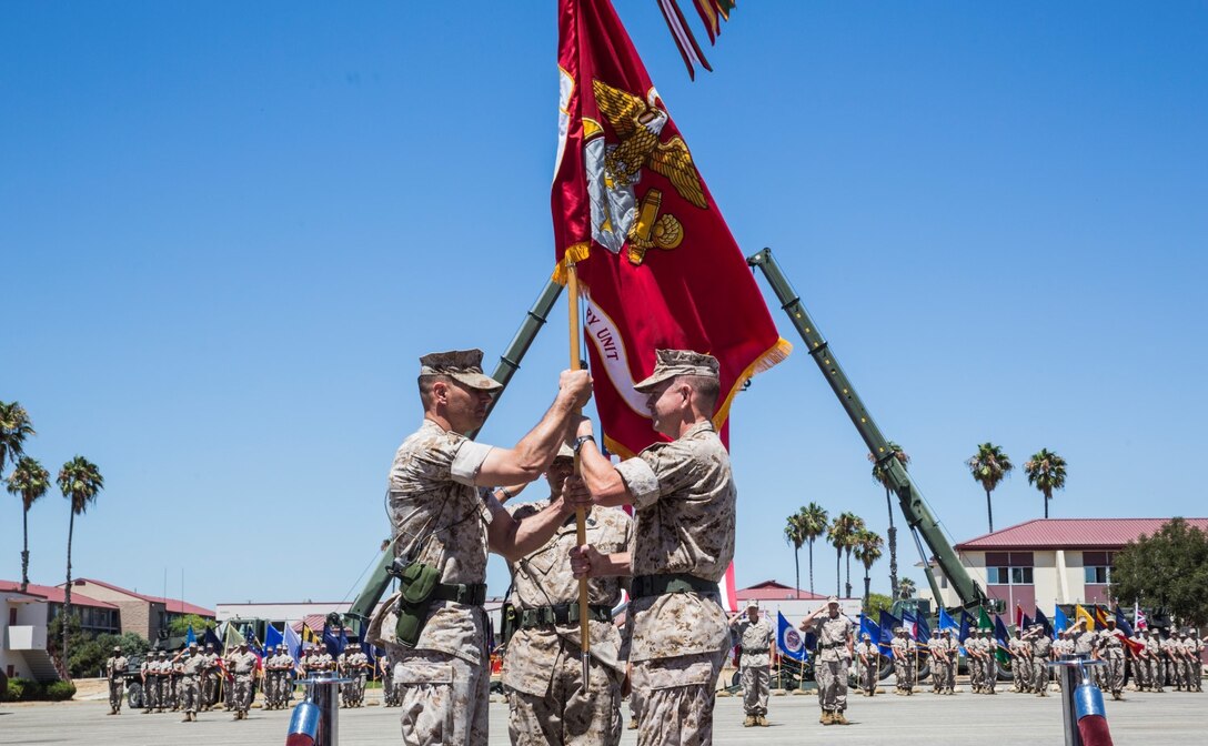 Colonel Vance L. Cryer takes the 15th Marine Expeditionary Unit’s colors from Lt. Col. John R. O’Neal symbolizing the transfer of leadership of the unit during a change of command ceremony aboard Camp Pendleton, Calif., July 10, 2014. (U.S. Marine Corps photo by Cpl. Emmanuel Ramos/Released)