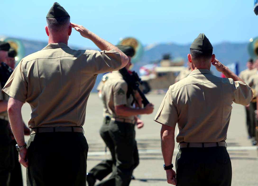 Lt. Col. Timothy M. Bairstow (left) and Lt. Col. Stephen V. Fiscus (right) salute Marines of 2nd Battalion, 5th Marine Regiment, 1st Marine Division, I Marine Expeditionary Force, during a change of command ceremony aboard Marine Corps Base Camp Pendleton, Calif., July 9, 2014. Fiscus took over command of the unit from Bairstow, the previous commanding officer.