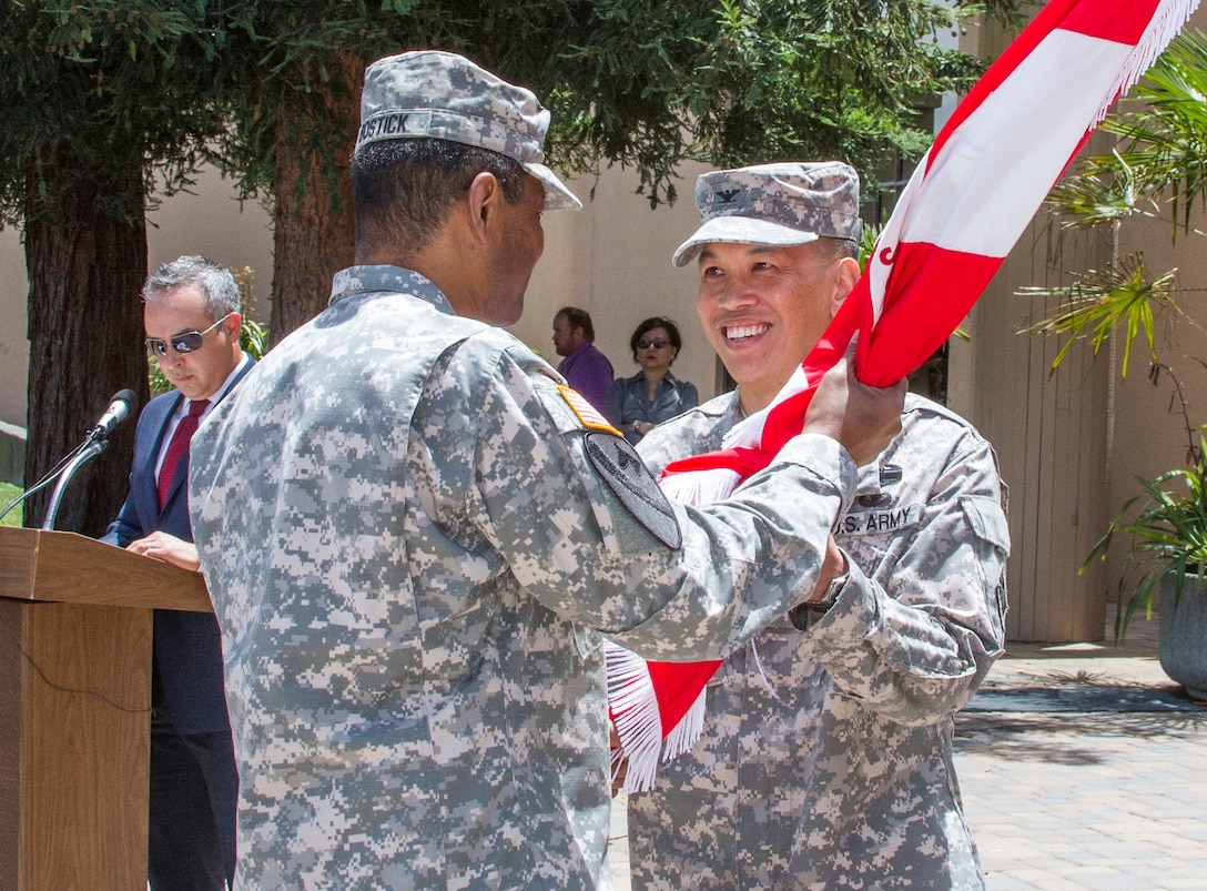 U.S. Army Corps of Engineers Chief, Lt. Gen. Thomas P. Bostick, passes the USACE South Pacific Division flag to Colonel (Promotable) Mark Toy during a ceremony at the Bay Model in Sausalito, Calif., June 30, 2014. COL (P) Toy assumed command from Brig. Gen. C. David Turner. COL (P) Toy spoke about returning to SPD and that taking care of people is our highest priority. 