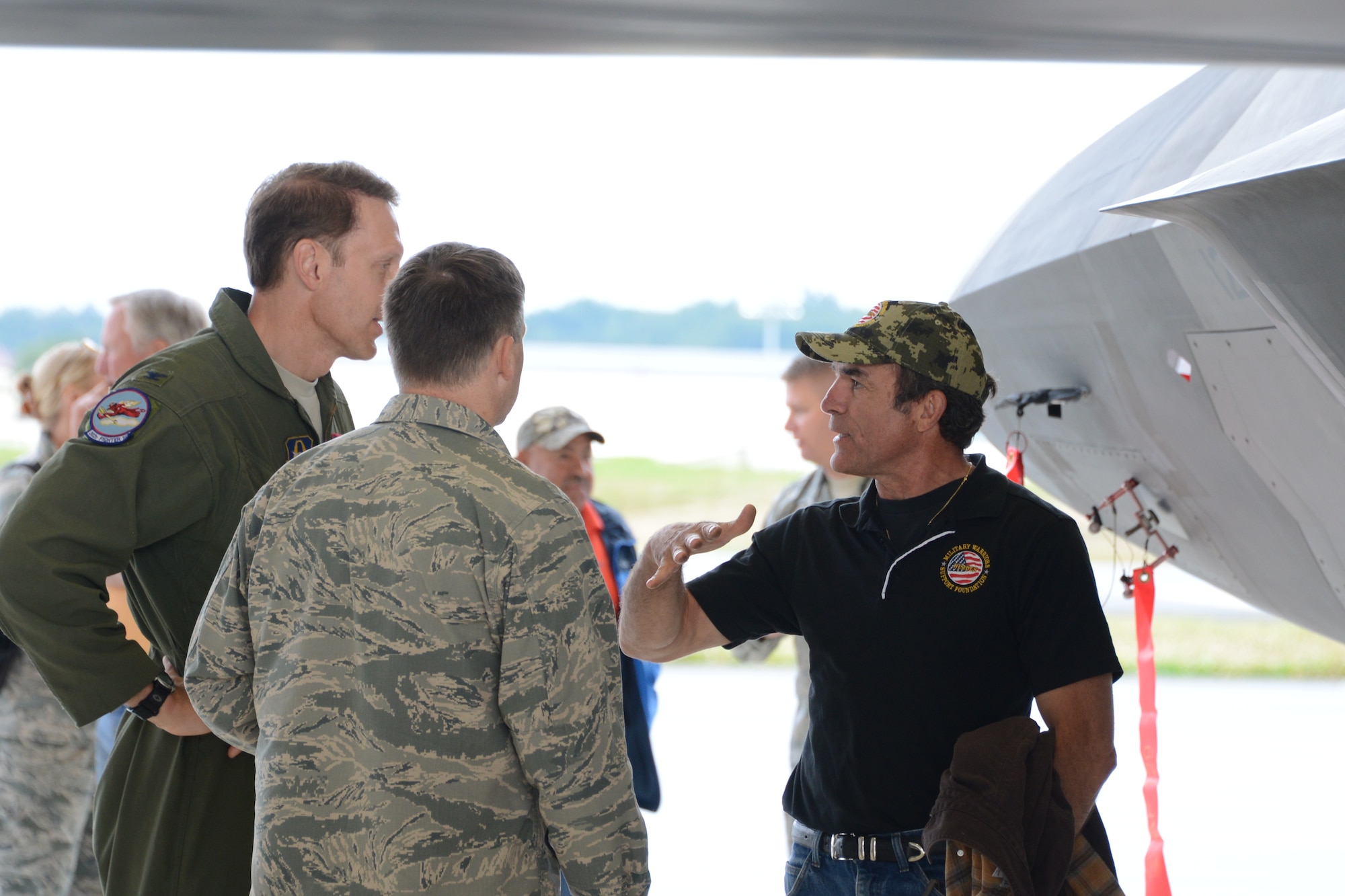 Col. Tyler Otten, 477th Fighter Group commander, and Col. David Piffarerio, 477th Fighter Group deputy group commander show John Yenason, from Military Warrior Support Foundation, around an F-22 here July 11. The Military Warrior Support Foundation provides academic and employment assistance to veterans and donates houses to Veterans and their families. (U.S. Air Force/Tech. Sgt. Dana Rosso) 
