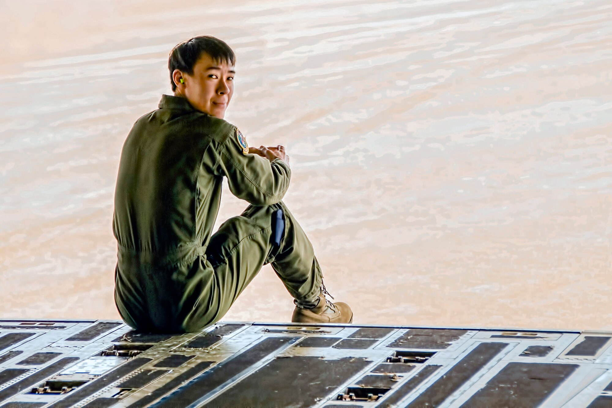 Tech. Sgt. Lenny Dewitt, a 728th Airlift Squadron loadmaster from Joint Base Lewis-McChord, Washington, checks his five before surveying the Semi-Prepared Runway [dirt landing strip] while aboard a McChord C-17 Globemaster III aircraft at Fort Hunter-Liggett, California, Jan. 31. Dewitt is also a full-time customer service agent with Alaska Airlines, which he began in 2013. (U.S. Air Force Reserve photo by Jake Chappelle)