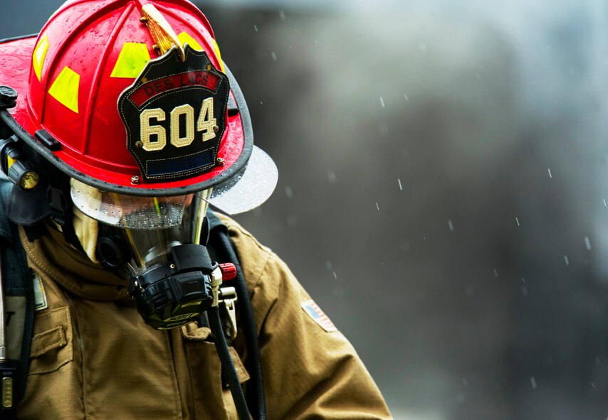 A volunteer fireman from the Burlington Fire Department takes a break after putting out a fire during a training exercise in Burlington, N.D., June 23, 2014. Members of the Minot Air Force Base Fire Department provided training to surrounding volunteer fire departments to assist them with their training needs. (U.S. Air Force photo/Senior Airman Brittany Y. Bateman)