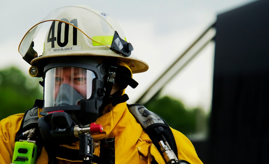 A volunteer fireman from the Burlington Fire Department watches as his team members put out a fire during a training exercise in Burlington, N.D., June 23, 2014. Burlington Fire Department is an all-volunteer force. They respond to 50-70 calls per year, ranging from wild land to structure fires.  (U.S. Air Force photo/Senior Airman Brittany Y. Bateman)