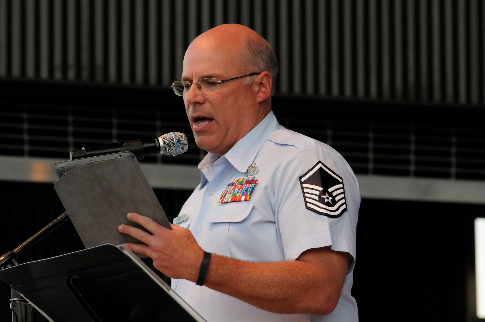 Master Sgt. Eric Odiorne reads a letter from a ???soldier to his sweetheart back in the states,??? as part of the Air National Guard Band of the South???s tribute to the armed forces, during their July 4, 2014 concert in Panama City, Fla. Odiorne is retiring from the service after service 24 years as a military percussionist. (U.S. Air National Guard photo by Senior Master Sgt. Paul Mann/Released)